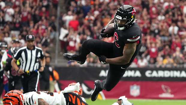 Arizona Cardinals running back James Conner (6) dives for extra yards against the Cincinnati Bengals at State Farm Stadium in Glendale on Oct. 8, 2023.